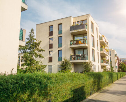 beautiful and modern white apartment buildings with street in the foreground